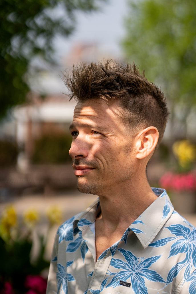 Close-up shot of a man outside and light reflecting on his face.