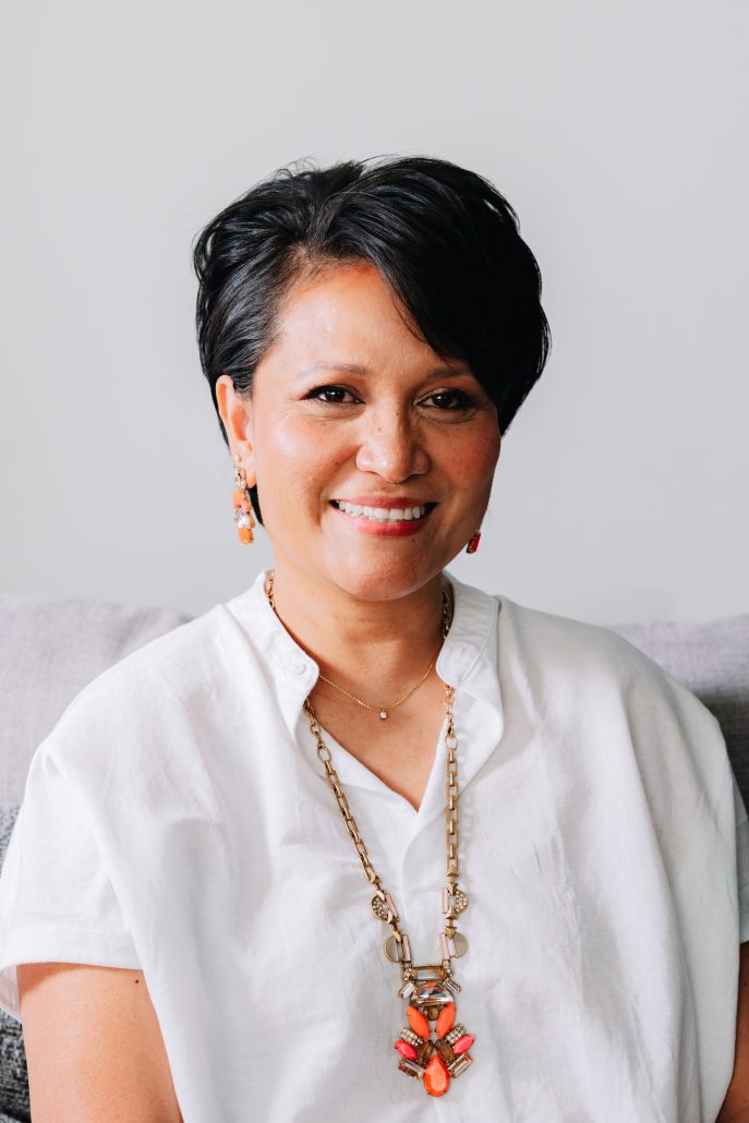 Profile of woman wearing a white shirt.