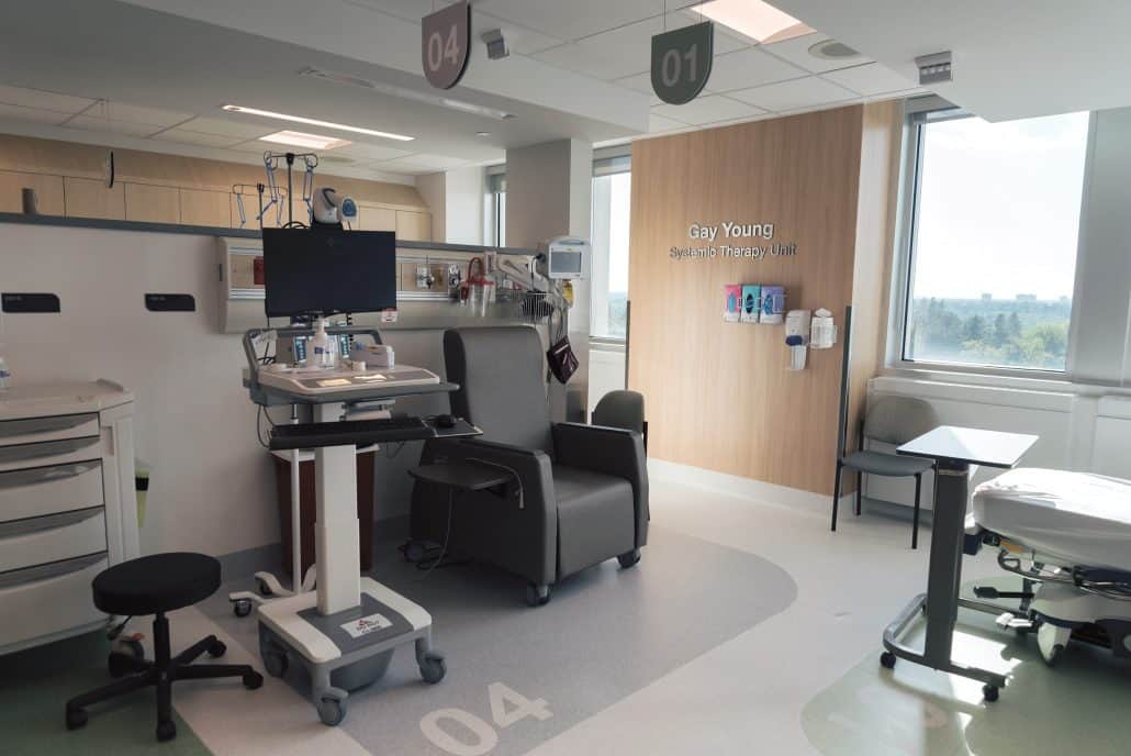 Image of a therapy unit which a chair, medical equipment and a bright window.
