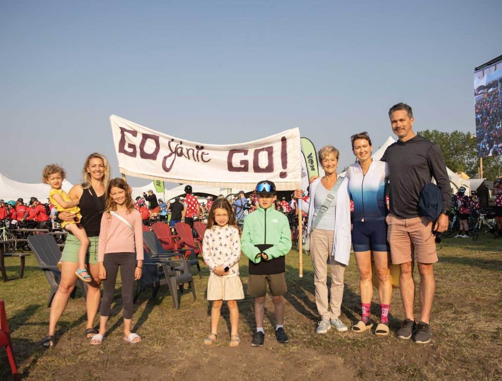 Family posed with encouraging sign.