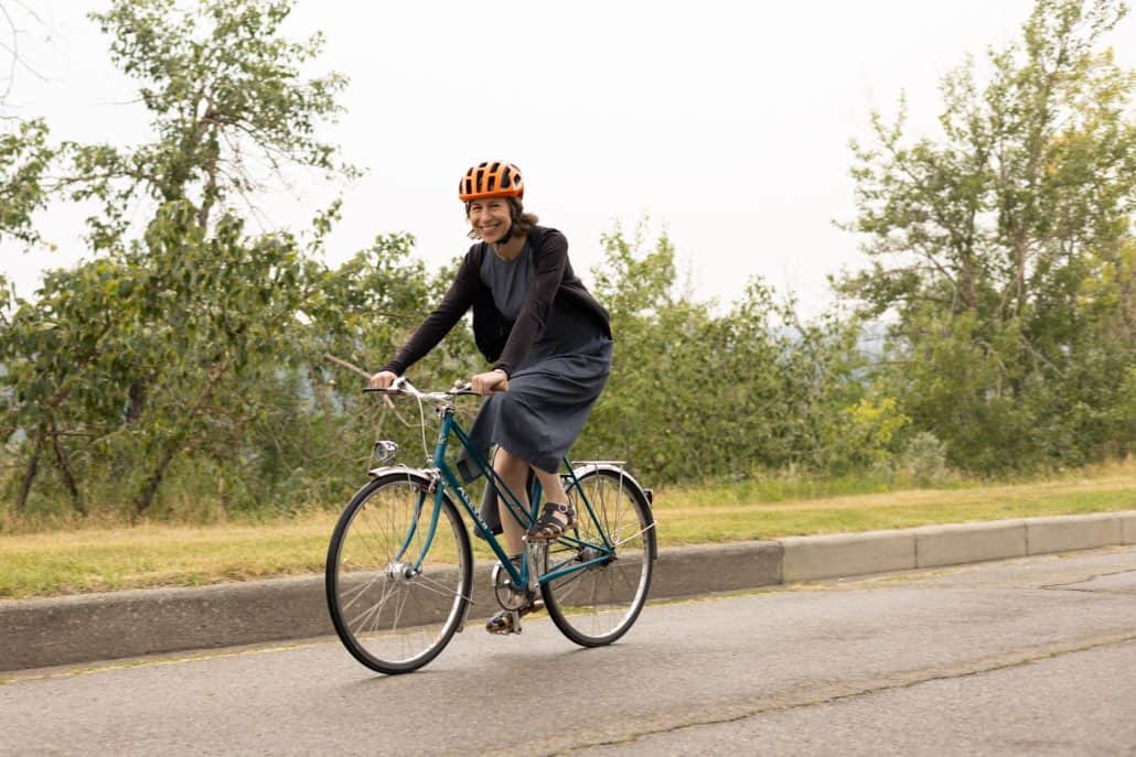 Women riding her bicycle.