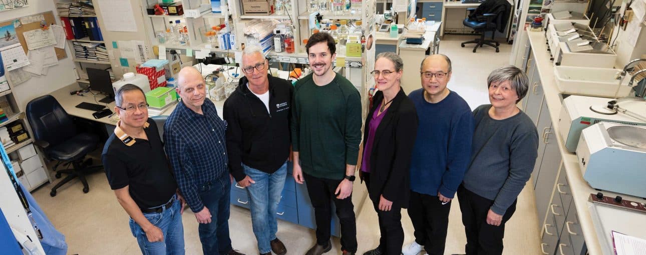 Team of medical professionals standing in a lab.