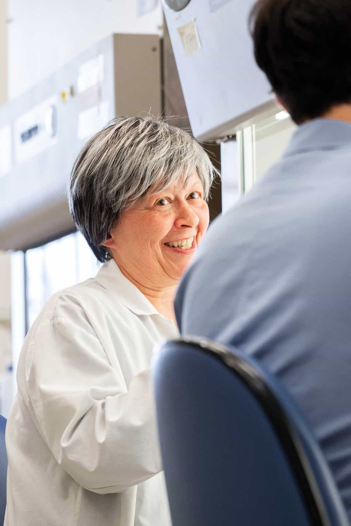 Doctor smiling in white coat.
