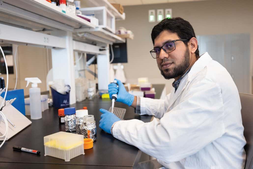 Researcher in white lab coat. 